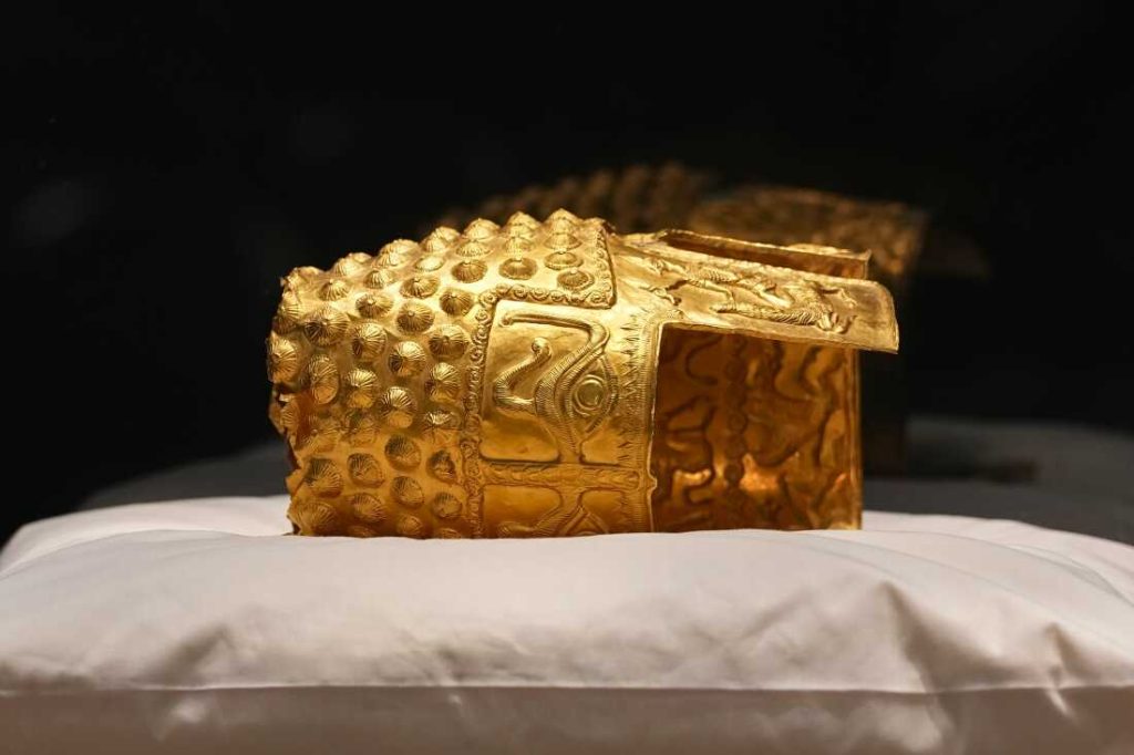 Dacian gold items, a 2,500-year-old helmet and wristbands, stolen from a museum in the Netherlands and then recovered by Dutch authorities, are presented during a press conference after being returned, at the National Museum of Romanian History, in Bucharest, Romania, Tuesday, April 21, 2026.