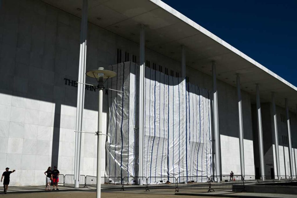 A tarp covers the facade of the John F. Kennedy Memorial Center for the Performing Arts in Washington, DC, on June 13. A federal judge has asked the arts complex's leadership to explain the purpose of the tarp and the surrounding scaffolding.