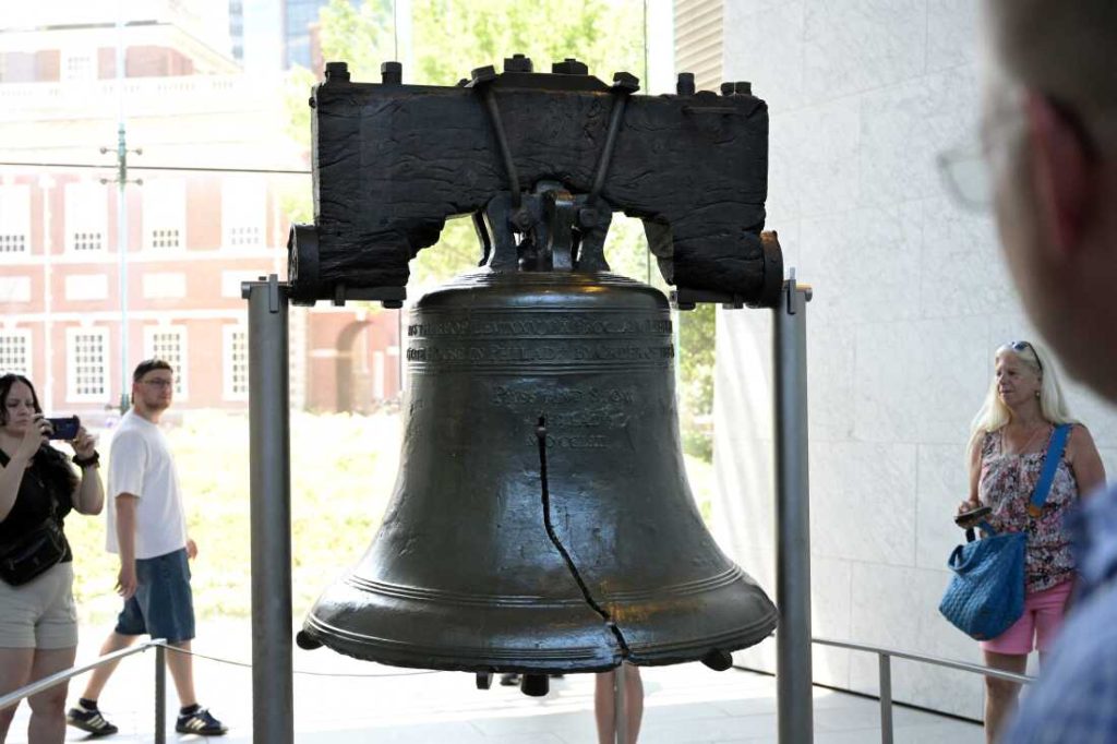 People visit the Liberty Bell on the eve of Independence Day in Philadelphia, Pa. on July 3, 2025. The crack in this symbol of U.S. freedom echoes the paradox between national pride and civic ignorance revealed in a new national poll.